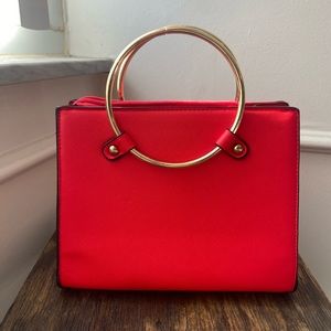 Red faux leather handbag